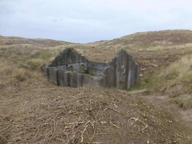 One of four surviving roofless structures thought to be the earliest known surviving group of mass-concrete magazines, dating to the 1890s.